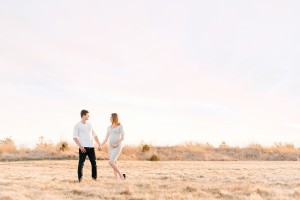 golden hour maternity photo with pink sunset