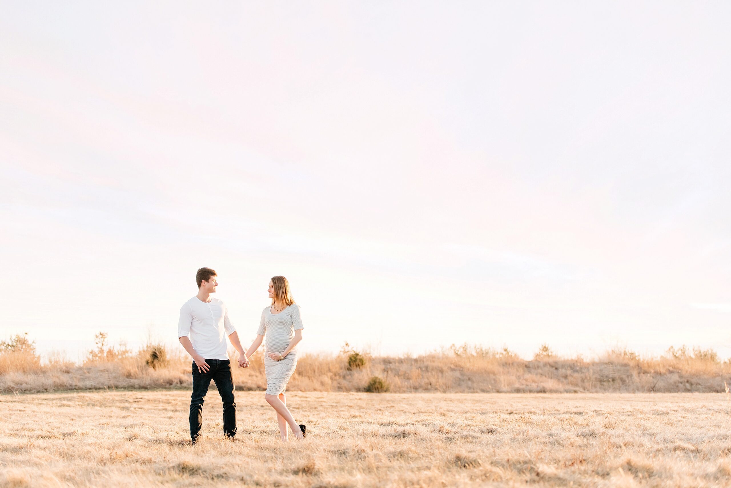 golden hour maternity photo with pink sunset