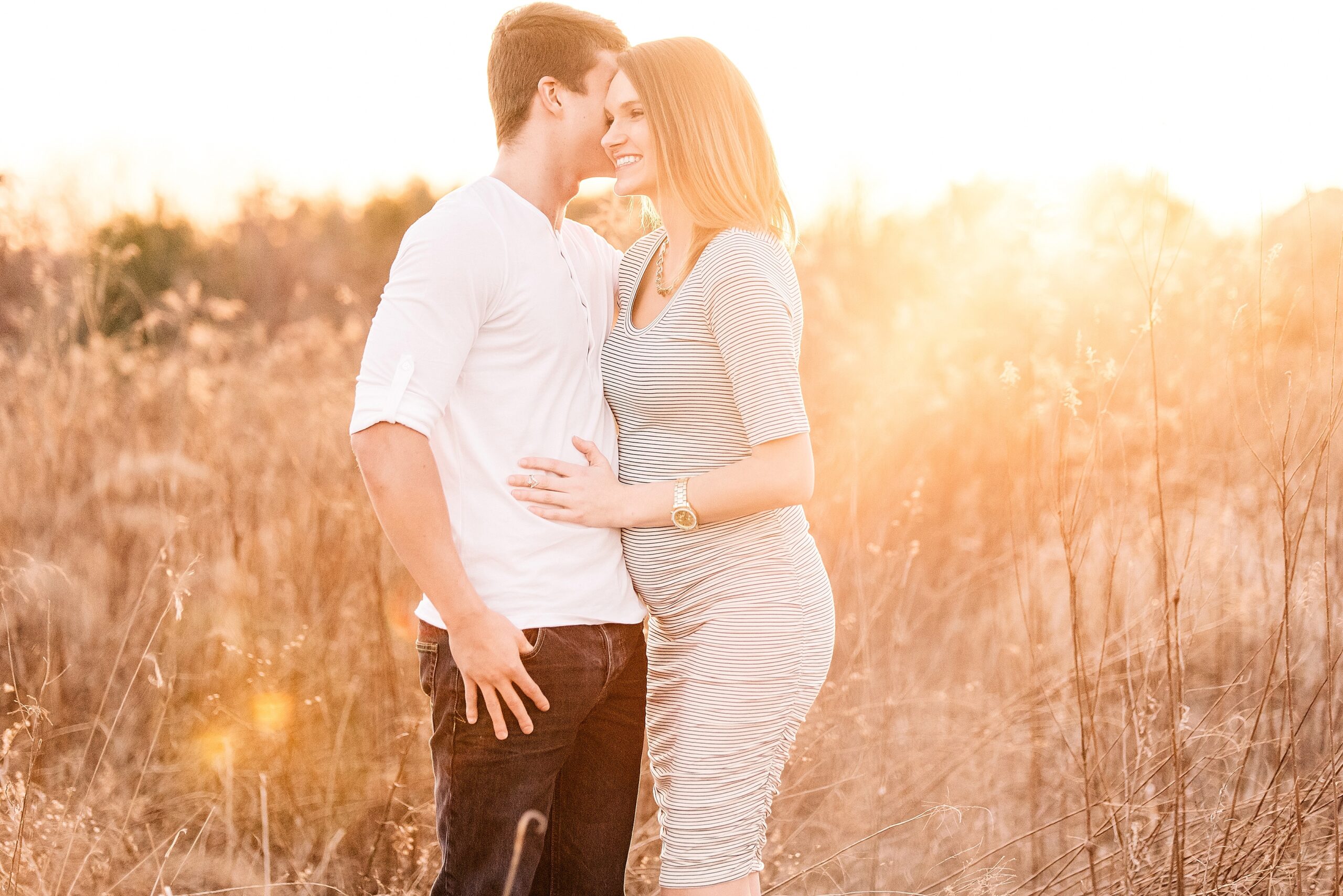 golden hour maternity photo laughing
